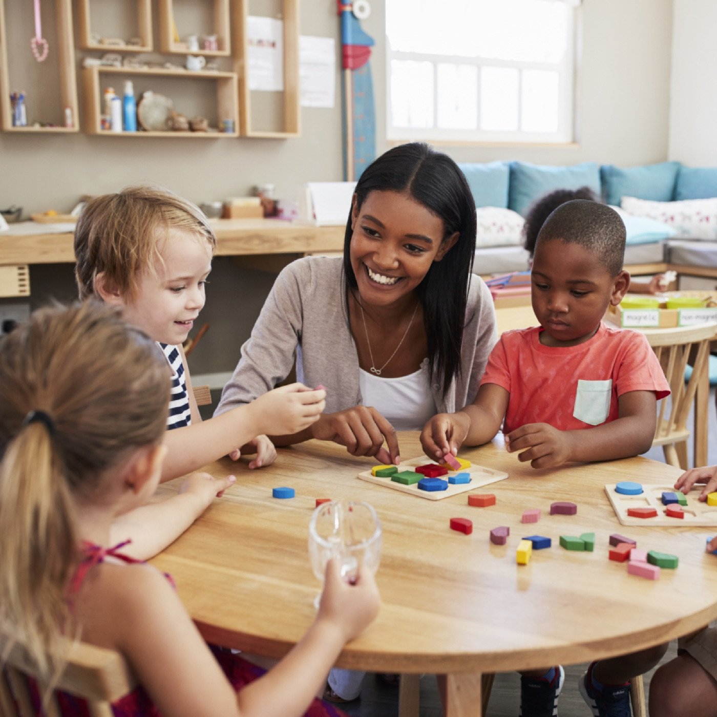 Teacher and children playing a hands-on learning game