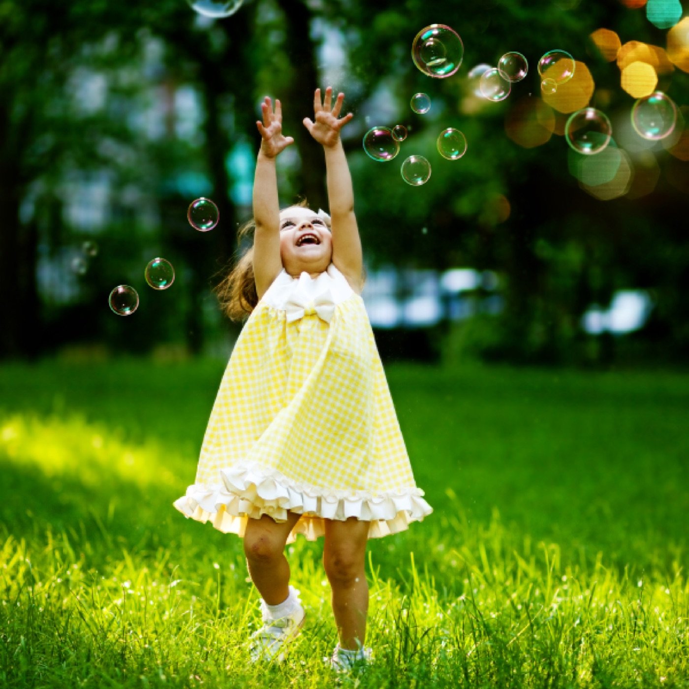 Little girl playing with bubbles outdoors
