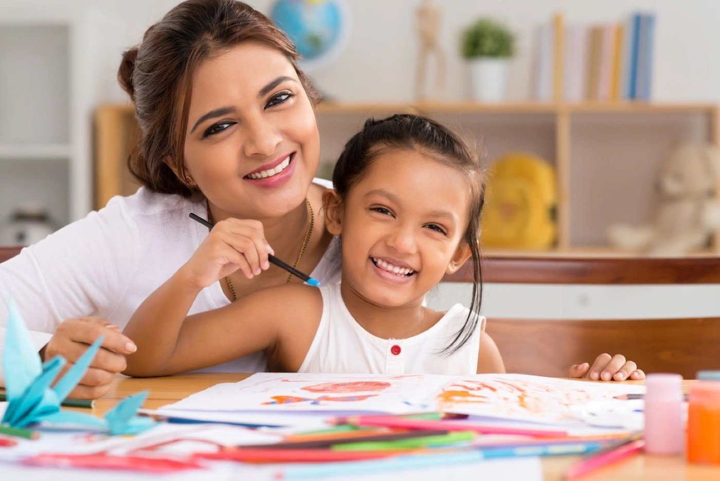 Mother and daughter smiling during a learning activity