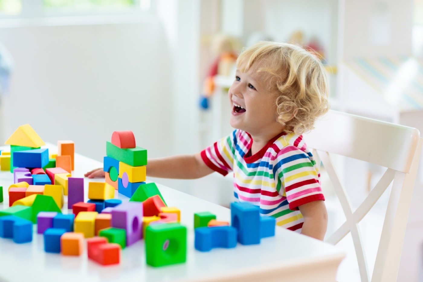 Toddler playing with colorful building blocks